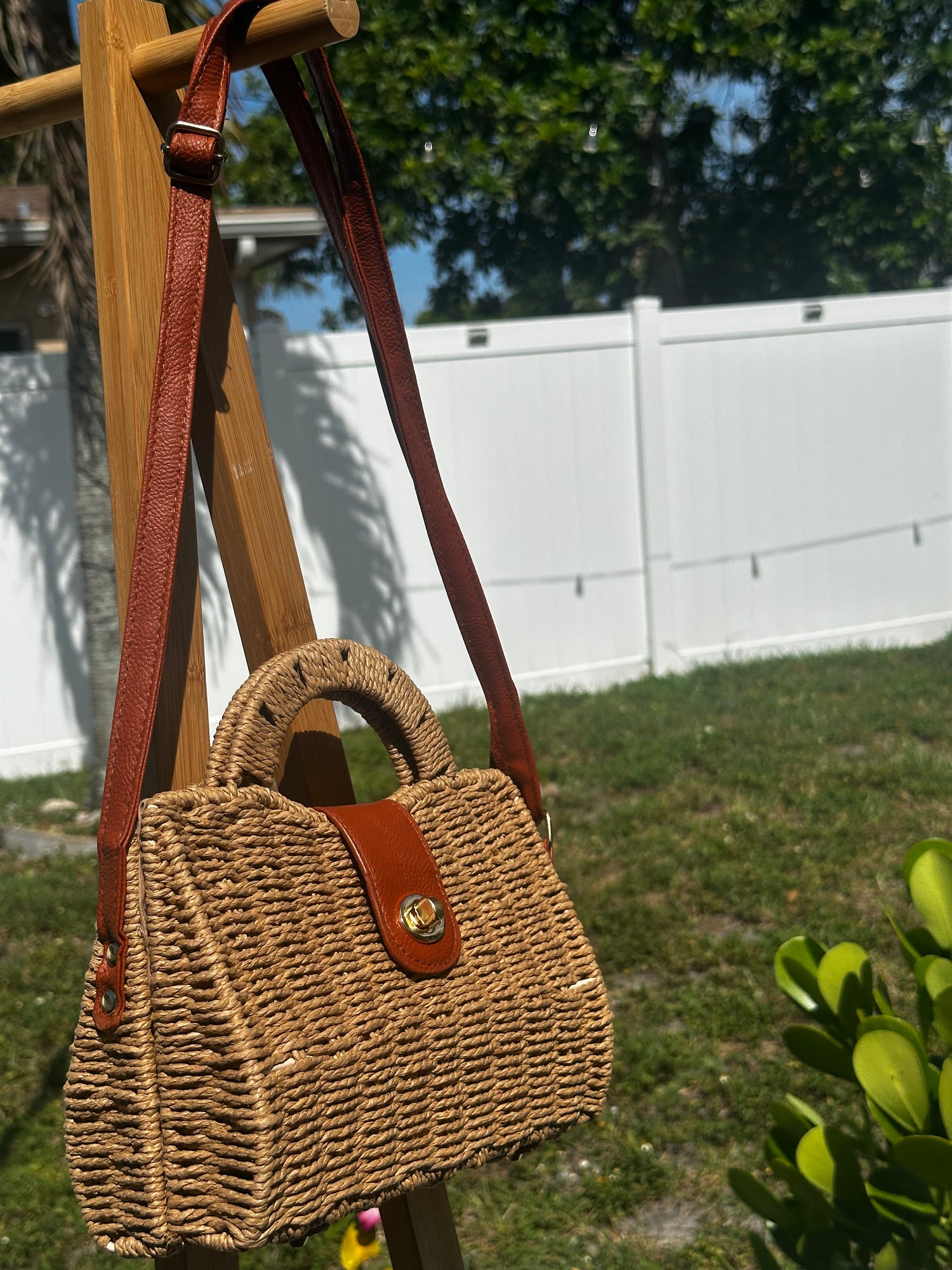 Mini Coastal Crossbody Bag with a stylish woven design and brown leather strap, perfect for beach outings and city adventures.